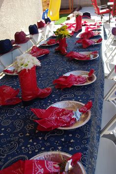 the table is set with red, white and blue napkins on it's place mats