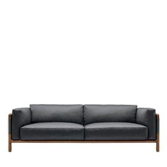 a gray couch with wooden legs on a white background