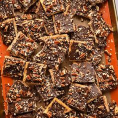 a tray filled with chocolate and pecans on top of a table