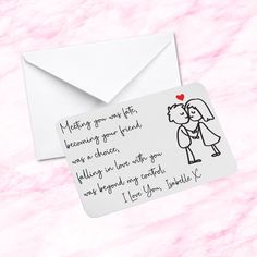 an envelope with a handwritten love note attached to it, next to the envelope is a drawing of a kissing couple