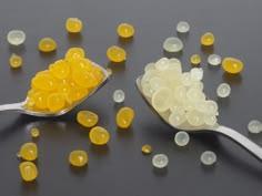 two spoons filled with yellow and white gummy bears