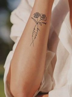 a woman with a flower tattoo on her arm