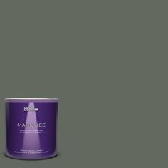 a can of behr marquee paint on a green background