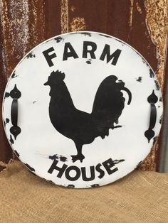 a white and black sign that says farm house with a rooster on it's side