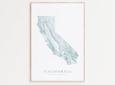 a framed map of the state of california in blue and white, on a wall