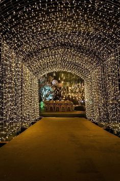 the inside of a tunnel covered in lights