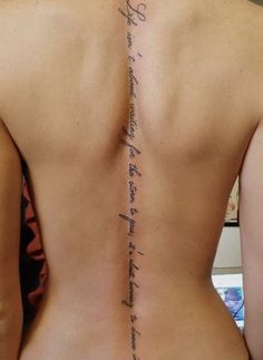 the back of a woman's upper body with writing on her left side and lower back