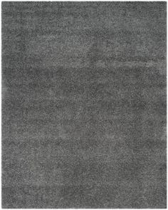 an area rug with dark gray carpeting