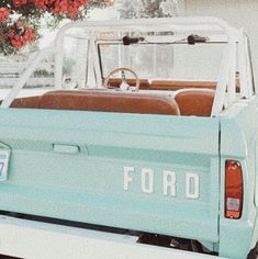 an old ford pick up truck parked in front of a house