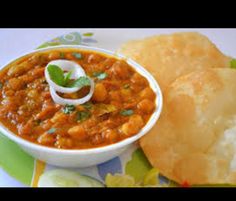 a bowl of soup and some bread on a plate