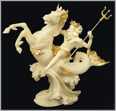 a statue of a mermaid riding a white horse with an anchor on it's back