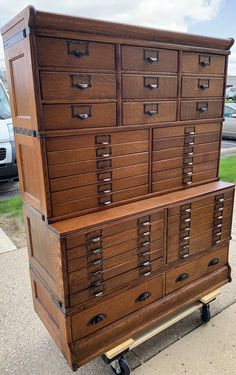 a large wooden dresser sitting on top of a dolly