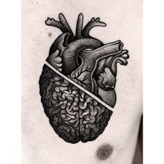 a man's chest with a black and white drawing of a human heart on it