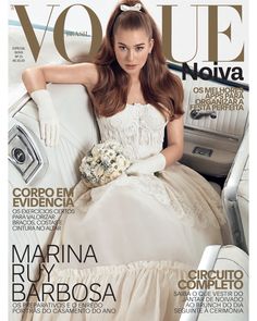 a woman sitting on top of a car wearing a white dress and holding a bouquet