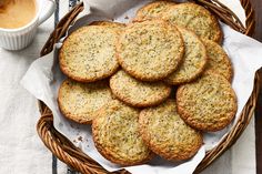 a basket filled with cookies next to a cup of coffee