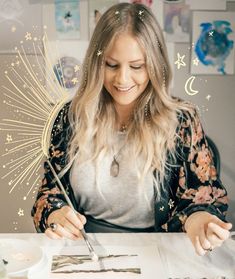 a woman sitting at a table with a pen and paper