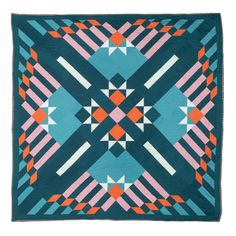 a blue and orange quilt with an abstract design