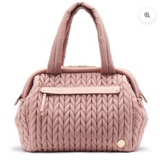 the pink handbag is on display in front of a white background with an image of a