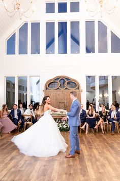 a bride and groom dancing in front of an audience