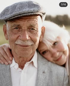 an older man and woman are smiling for the camera