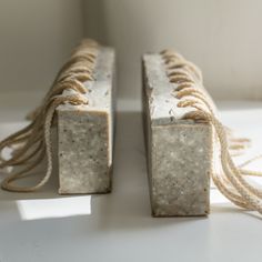 two soap bars are tied together on a table