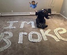 a man kneeling on the floor in front of a sign that says time to stop