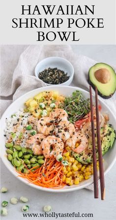 a bowl filled with shrimp, carrots and avocado next to chopsticks