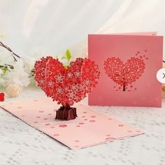 two valentine's day cards, one with a tree and the other with hearts