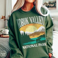 Show off your love of Alaska and one of our nation's most majestic national parks in our Kobuk Valley National Park Sweatshirt! This comfy crewneck is all about embracing the great outdoors, featuring a custom vintage design that showcases the grandeur of the Alaskan Wilderness and the vast mountain terrain of the Kobuk Valley itself! The Gildan 18000 50/50 blend fabric has that comfy, lived-in feel, that's like a hug every time you put it on! Now you can take a bit of Kobuk with you wherever yo Ohio Sweatshirt, National Park Sweatshirt, Pinnacles National Park, Maine Trip, Cuyahoga Valley National Park, Comfy Crewneck, Beautiful Parks, Maine Vacation, Hiking Gifts