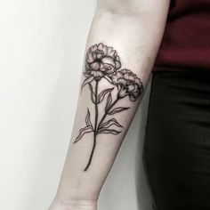 a black and white flower tattoo on the arm