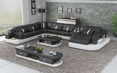 a modern living room with black and white leather sofas, coffee table and end tables