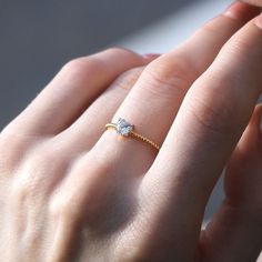 a woman's hand with a diamond ring on it