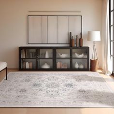 a living room with a large rug on the floor next to a couch and window