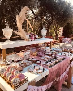 a table topped with lots of desserts and pastries