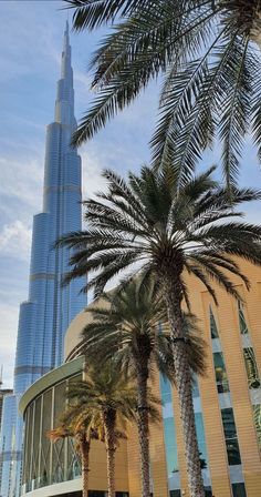 the burj building is surrounded by palm trees