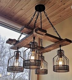 three light fixtures hanging from a wooden beam