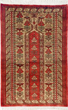 an old rug with red and beige colors on the bottom, surrounded by white fringes