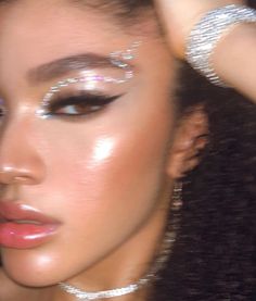 a close up of a woman with shiny makeup