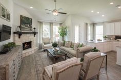 a living room filled with furniture and a flat screen tv on top of a fireplace