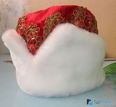 a red and white hat sitting on top of a table