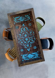 an overhead view of a table with chairs and a painting on the wall above it