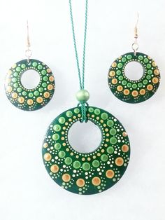 two pieces of green and yellow painted jewelry