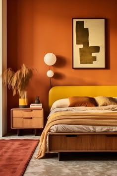 a bedroom with an orange wall and wooden furniture