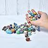 a hand reaching out to grab some beads from a pile on a table with white background