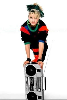 a woman is leaning on top of a radio