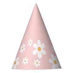 a pink party hat with white and yellow daisies on the front, sitting on a white background