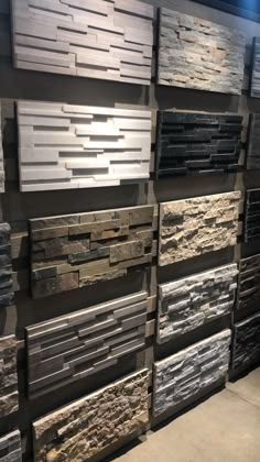 a wall with many different types of stone tiles on the walls and flooring in it