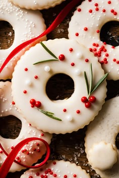 some white donuts with red and green sprinkles