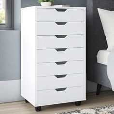 a white chest of drawers in a bedroom