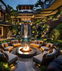 a fire pit surrounded by couches and chairs in the middle of a courtyard area